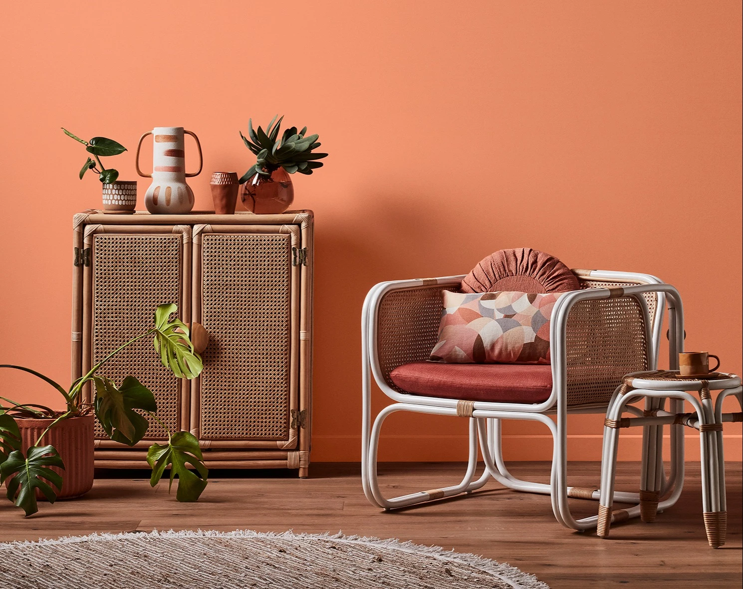 White and neutral themed living room with couch and buffet table against wall with decorative items.