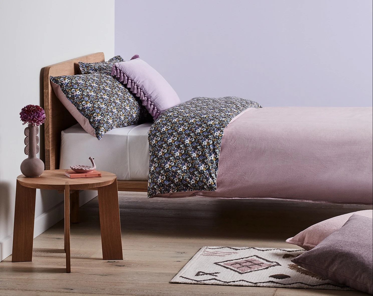 White and neutral themed living room with couch and buffet table against wall with decorative items.