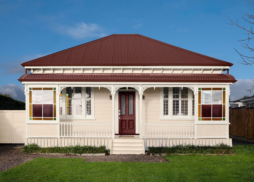 White and neutral themed living room with couch and buffet table against wall with decorative items.